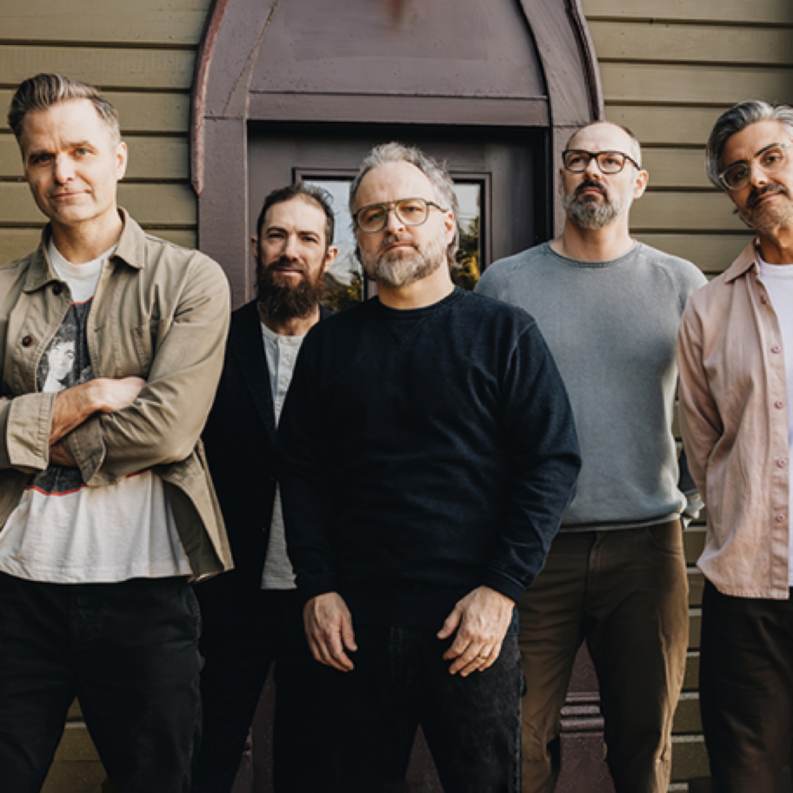 Death Cab for Cutie standing together in a promotional band photo.