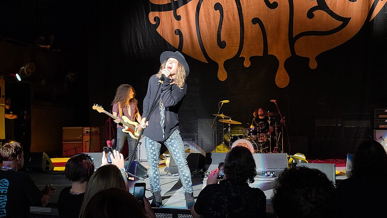 Dirty Honey performing together onstage.
