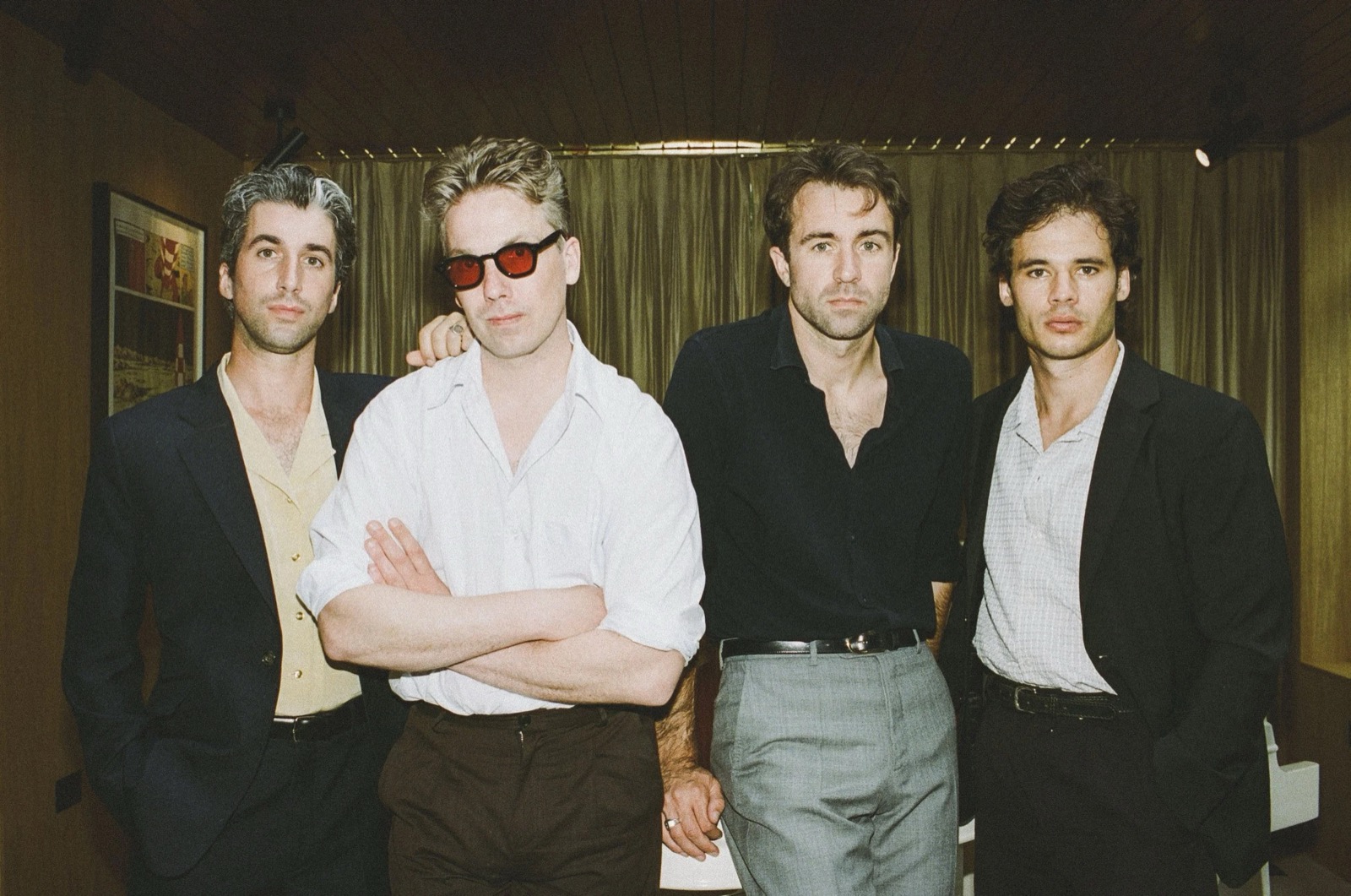 The Vaccines posing together in a warm-toned promotional band photograph.