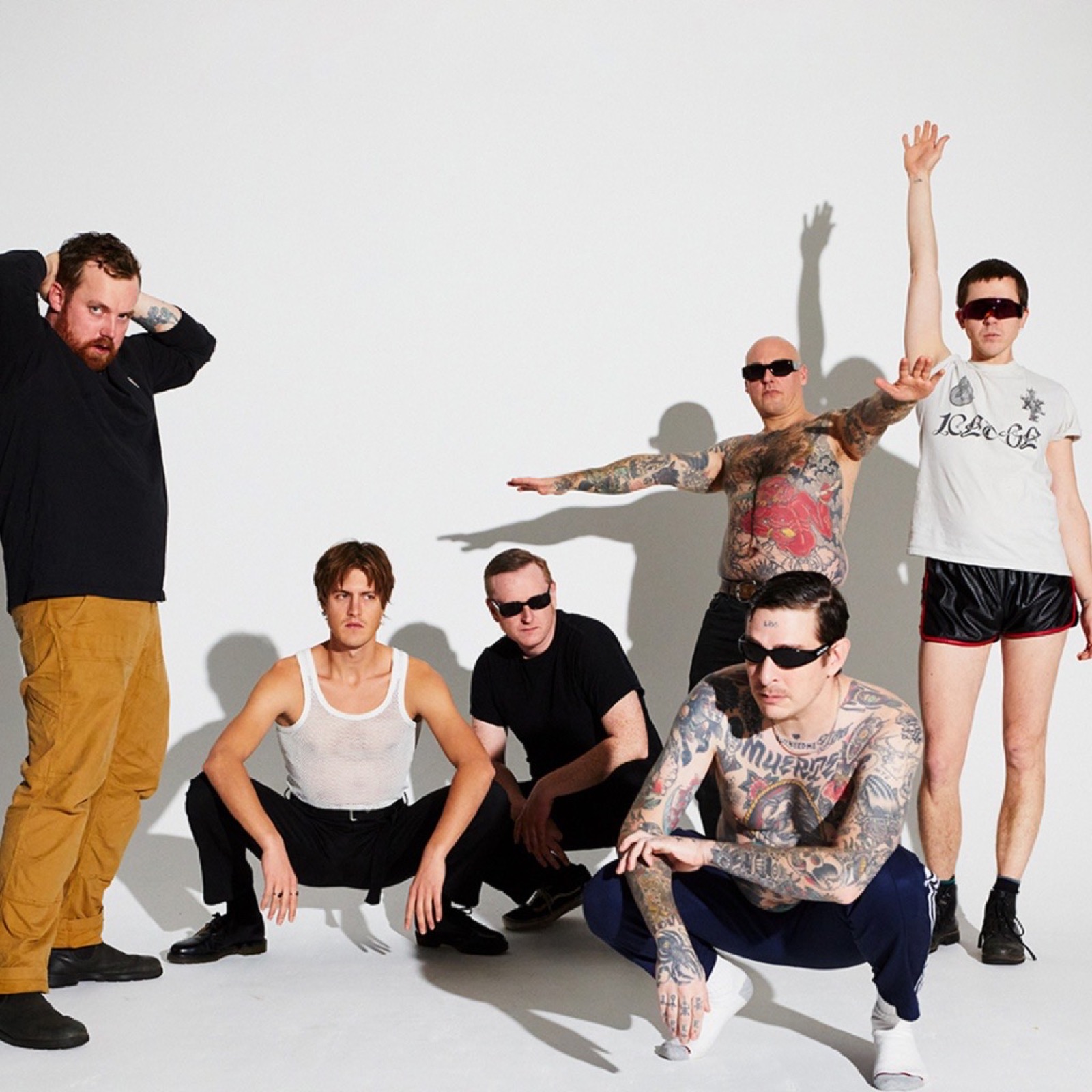 Viagra Boys posing together in a studio promotional photograph.